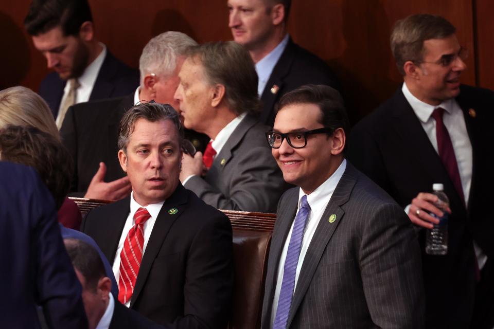 WASHINGTON, DC - JANUARY 04: U.S. Rep.-elect George Santos (R-NY) (R) talks to Rep.-elect Andy Ogles (R-TN) in the House Chamber during the second day of elections for Speaker of the House at the U.S. Capitol Building on January 04, 2023 in Washington, DC. The House of Representatives is meeting to vote for the next Speaker after House Republican Leader Kevin McCarthy (R-CA) failed to earn more than 218 votes on three separate Tuesday ballots, the first time in 100 years that the Speaker was not elected on the first ballot. (Photo by Win McNamee/Getty Images)