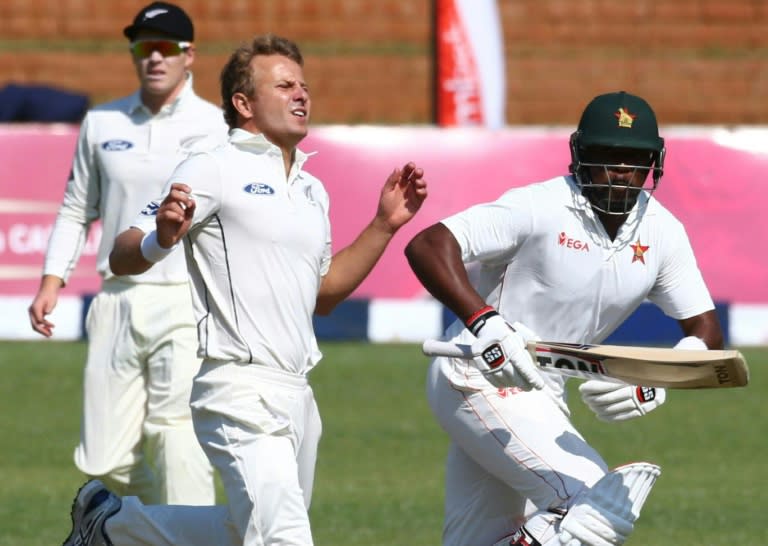 Zimbabwe batsman Hamilton Masakadza (R) runs past New Zealand bowler Neil Wagner during the first day of the first Test at Queens Sports Club in Bulawayo July 28, 2016