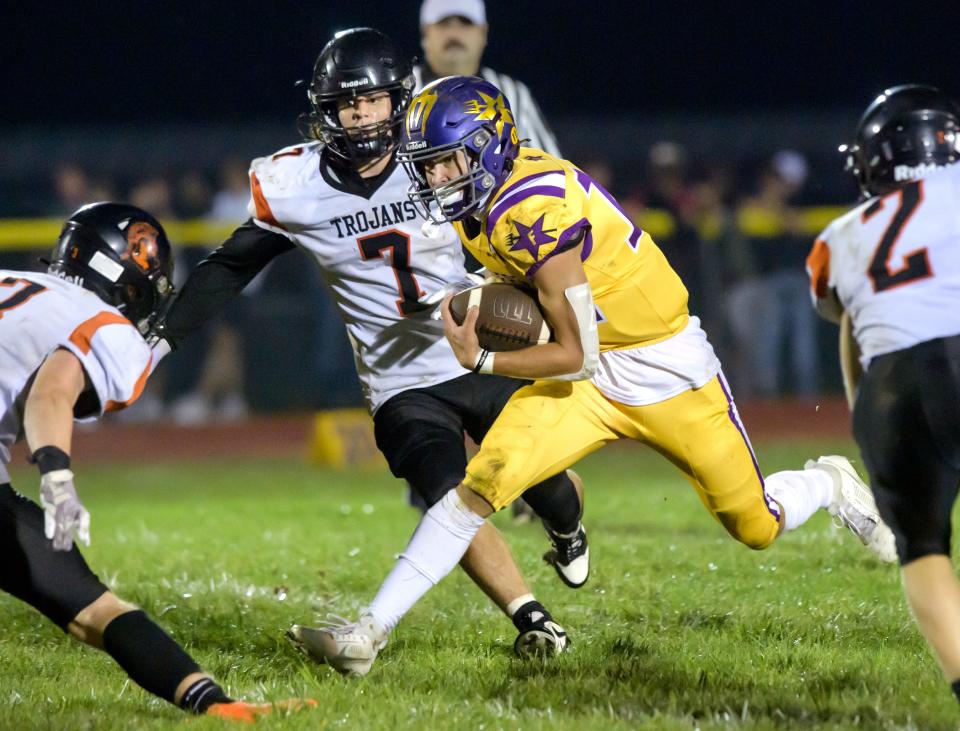 Farmington quarterback Lane Wheelwright scrambles through the Elmwood/Brimfield defense in the second half of their varsity football game Friday, Sept. 22, 2023 in Farmington. The Farmers defeated the Trojans 30-26.