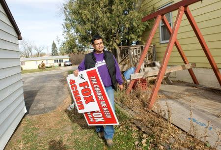 Three Affiliated Tribes council chairman candidate Mark Fox delivers signs to a supporter's house on the Fort Berthold Reservation in North Dakota, November 1, 2014. REUTERS/Andrew Cullen