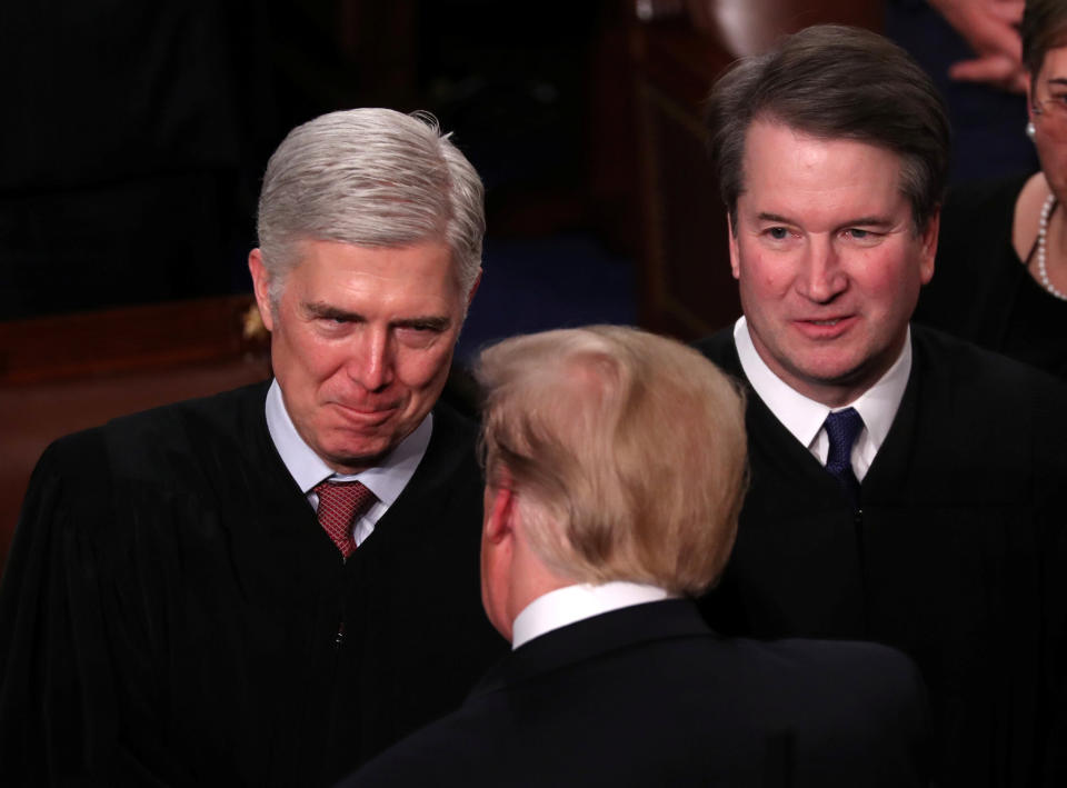 President Donald Trump talks with Supreme Court Justice Neil Gorsuch (L) and Justice Brett Kavanaugh on Capitol Hill in February. (Photo: Jonathan Ernst / Reuters)