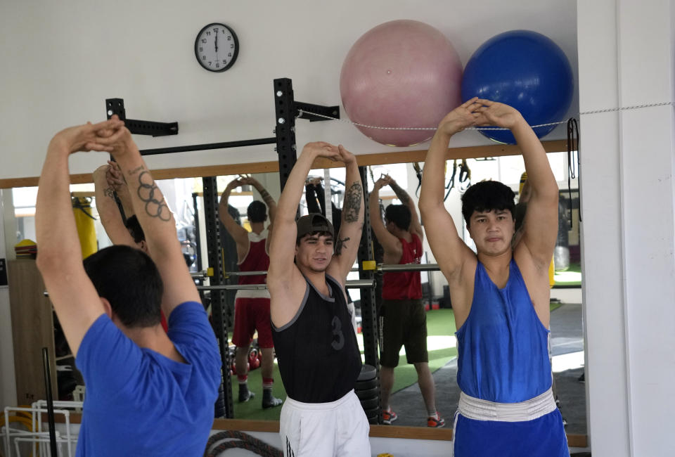 Members of the Afghan national boxing team stretch during a session in local gym in Serbia, Wednesday, Dec. 1, 2021. They practiced in secrecy and sneaked out of Afghanistan to be able to compete at an international championship. Now, the Afghan boxing team are seeking refuge in the West to be able to continue both their careers and lives without danger or fear. (AP Photo/Darko Vojinovic)