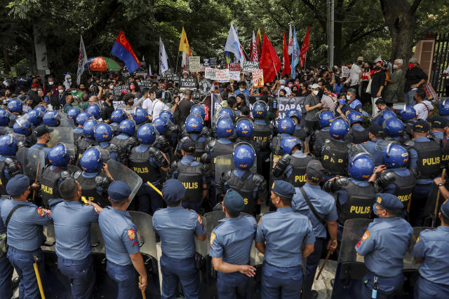Police block activists protesting the upcoming proclamation of presidential frontrunner Ferdinand "Bongbong" Marcos and running mate Sara Duterte, daughter of the current president, during a rally at the Commission on Human Rights in Quezon City, Metro Manila, Marcos Jr. continues to lead in the official canvassing of votes. (AP Photo/Basilio Sepe)