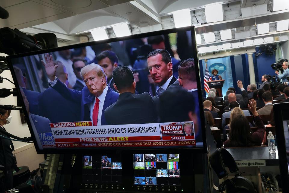 A television screen at the White House shows former President Donald Trump getting arraigned on April 4, 2023. <a href="https://media.gettyimages.com/id/1479796979/photo/press-secretary-karine-jean-pierre-briefs-the-white-house-media.jpg?s=1024x1024&w=gi&k=20&c=AKEUNmyigJoPpjDDwCZYkeyfAtBYNnHrd6cEdjqc_o8=" rel="nofollow noopener" target="_blank" data-ylk="slk:Kevin Dietsch/Getty Images;elm:context_link;itc:0;sec:content-canvas" class="link ">Kevin Dietsch/Getty Images</a>