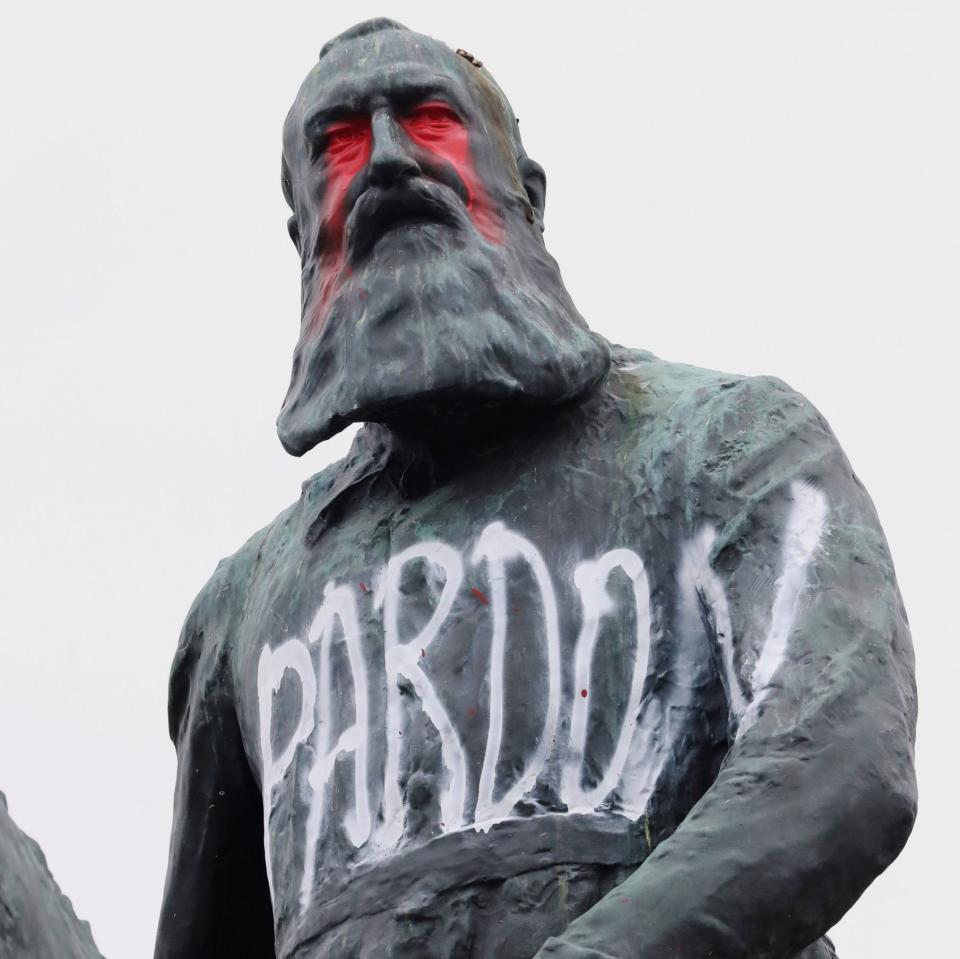 The vandalised statue of Leopold II outside the royal palace close to the centre of Brussels. - Reuters