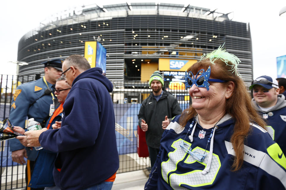 Football fans arrive at MetLife Stadium, Sunday, Feb. 2, 2014, in East Rutherford, N.J. The Seattle Seahawks are scheduled to play the Denver Broncos in NFL football's Super Bowl XLVIII game on Sunday evening. (AP Photo/Matt Rourke)