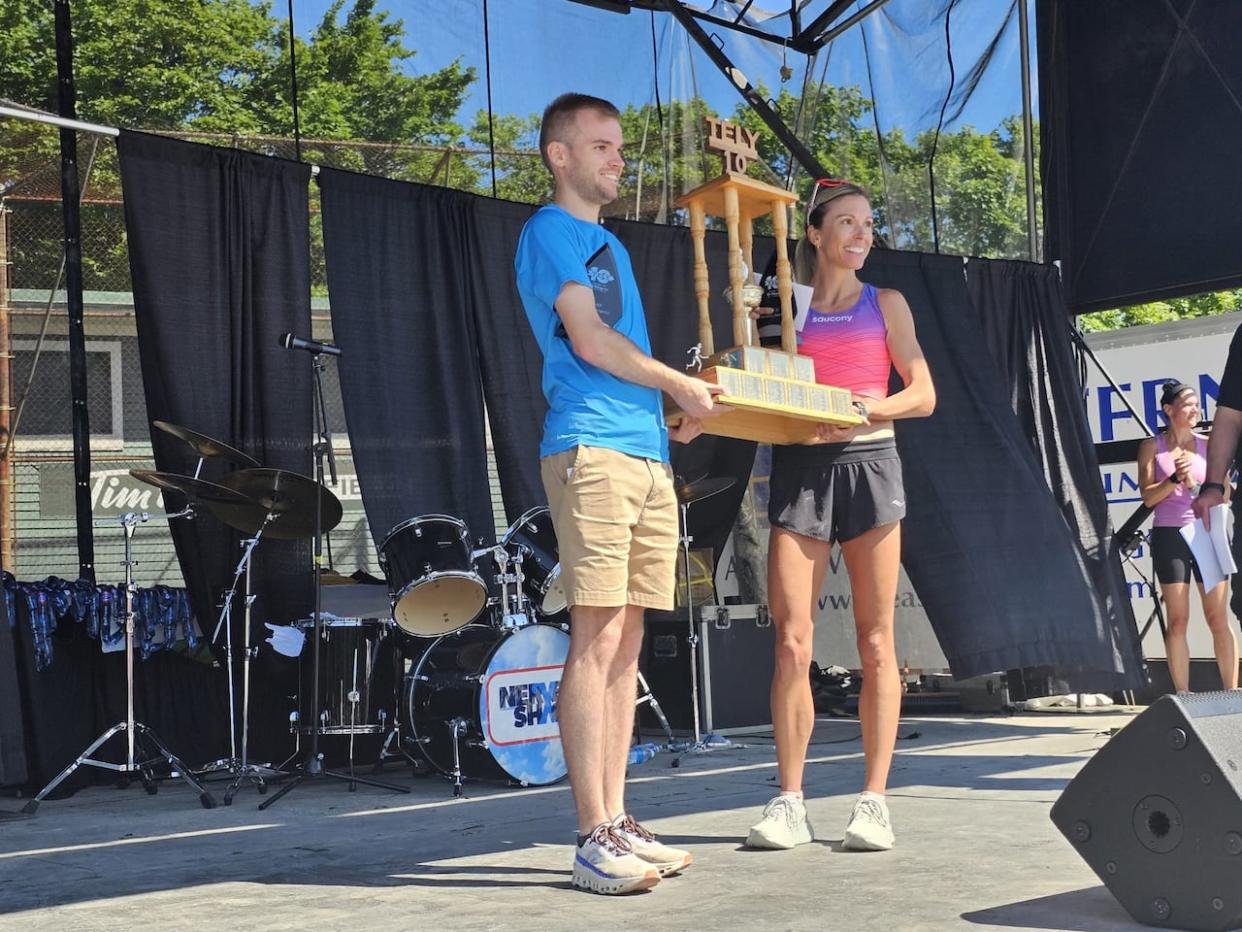 Callum Drever and Kate Bazeley accepting their awards for each coming in first in the Tely 10 race in their gender category. 