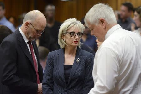 Family members Arnold (L) and Lois Pistorius (C) react to the sentencing of South African Olympic and Paralympic track star Oscar Pistorius at the North Gauteng High Court in Pretoria October 21, 2014. REUTERS/Herman Verwey/Pool