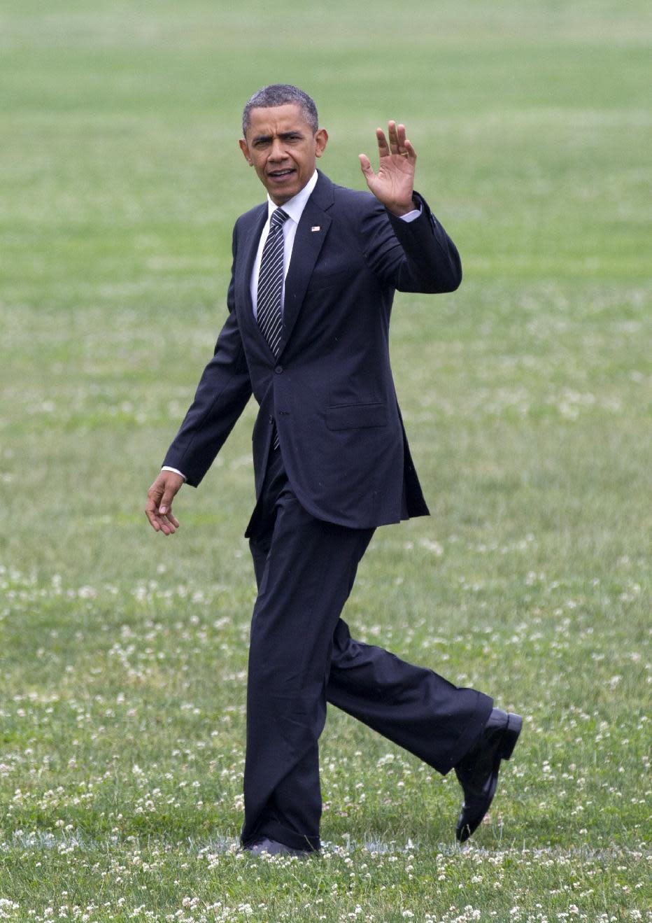 President Barack Obama waves as he walks across a grass field upon his arrival at McDonogh School in Owings Mills, Tuesday, June 12, 2012. (AP Photo/Carolyn Kaster)