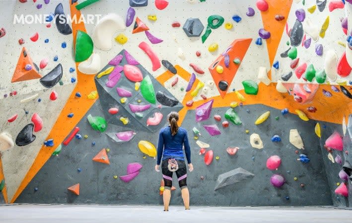 Woman standing in the middle of a bouldering gym