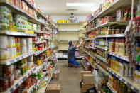 Volunteers stock shelves as they prepare for the residents of Fort McMurray displaced by a raging wildfire, in Anzac, Alberta, Canada May 4, 2016. REUTERS/Topher Seguin