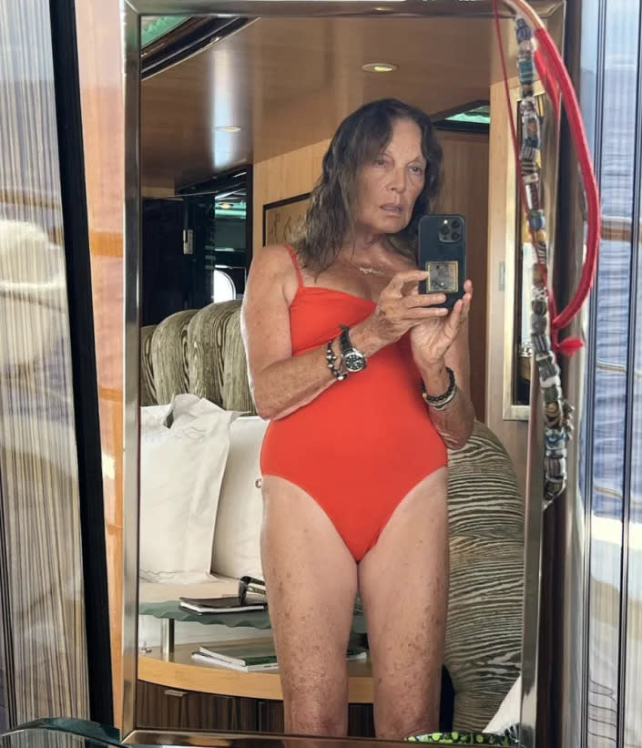 Diane von Furstenberg takes a selfie while wearing a red swimsuit. 