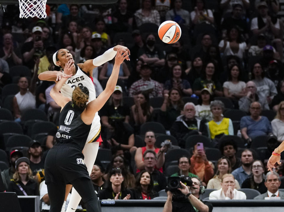 Las Vegas Aces forward A'ja Wilson (22) blocks the shot of Seattle Storm guard Kia Nurse (0) during the first half of a WNBA basketball game, Saturday, May 20, 2023, in Seattle. (AP Photo/Lindsey Wasson)