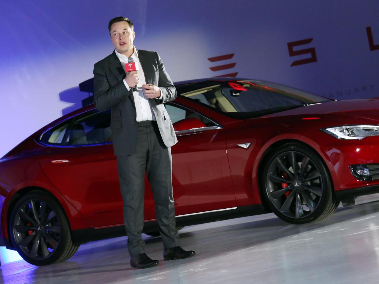 Tesla Motors CEO Elon Musk speaks to the media next to its Model S in Hong Kong on January 25, 2016.