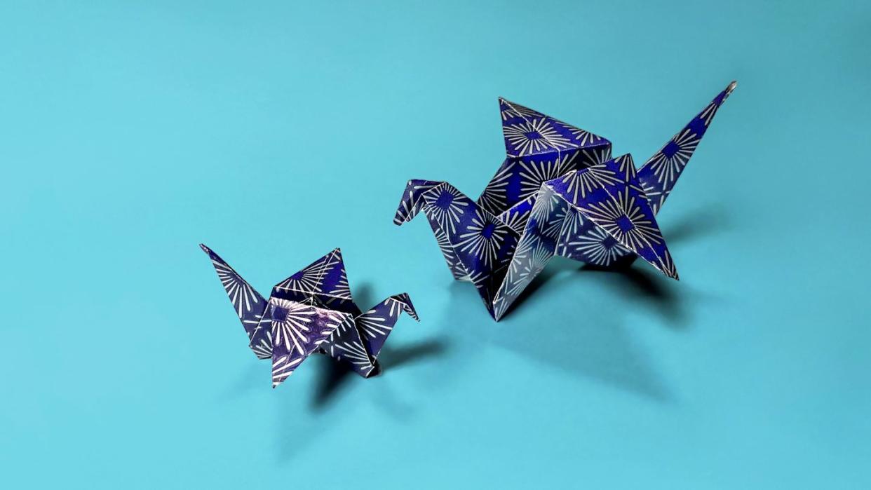 two cranes made from blue and silver paper