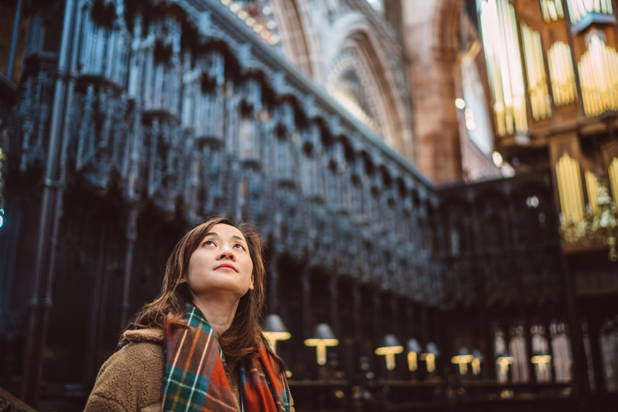 Young solo traveller visiting a cathedral, amazed by the beautiful architecture in europe