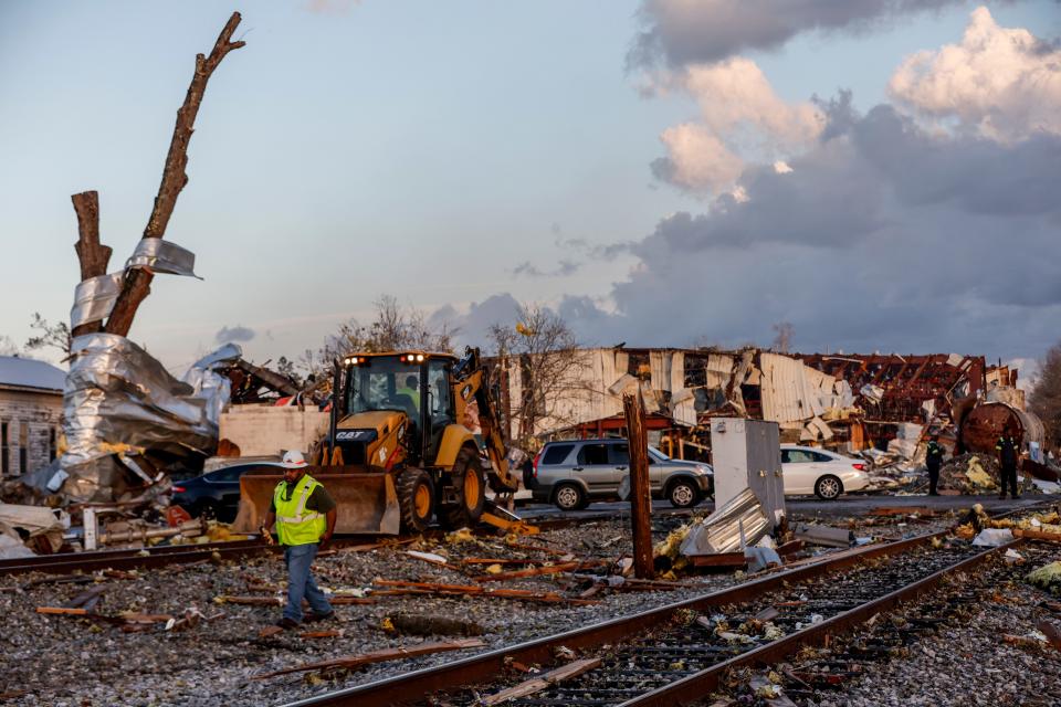 Workers remove debris from railroad tracks after a tornado passed through downtown Selma, Thursday, Jan. 12, 2023, in Selma Ala..