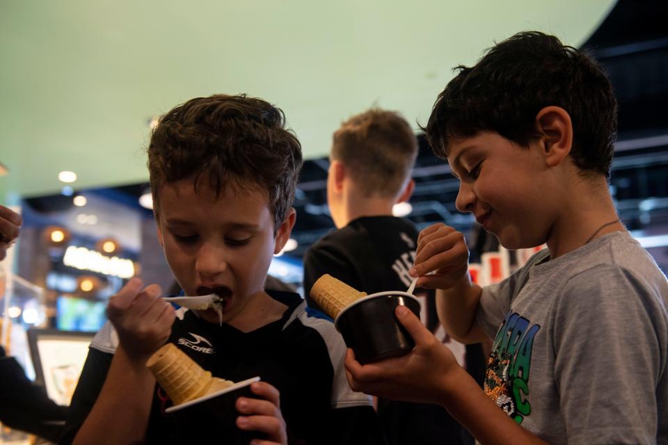 Ayden Hennings, 8 and Shawn Cohen, 8, enjoy ice cream at Hattie Jane's Creamery inside Assembly Food Hall  in Nashville, Tenn., Monday, May 29, 2023.