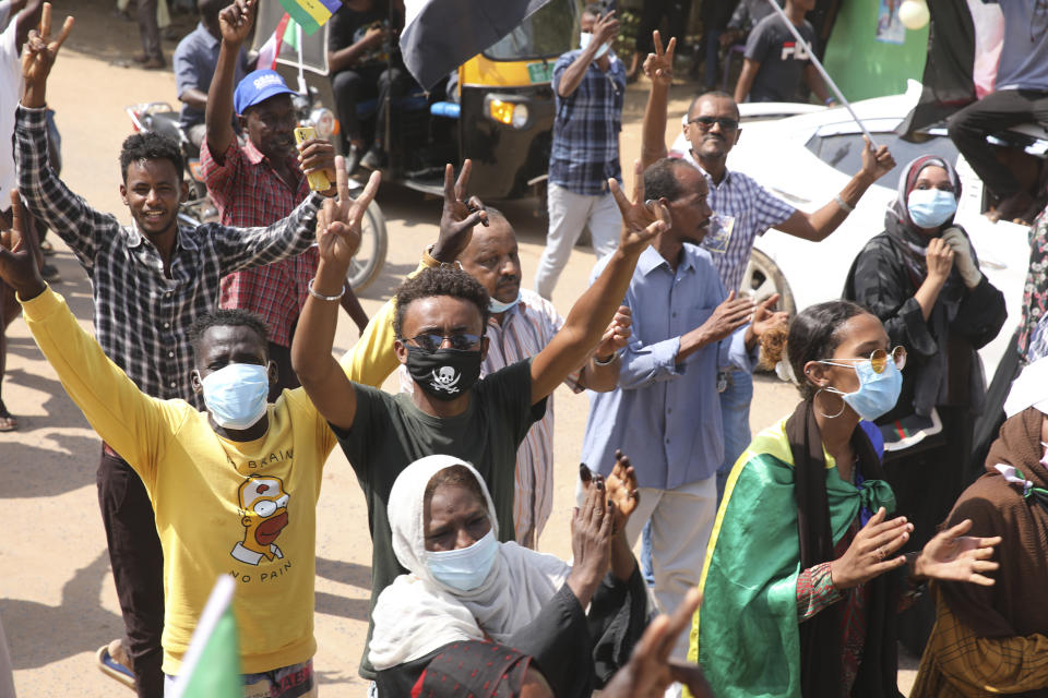 Sudanese demonstrators take to the streets of the capital Khartoum to demand the government's transition to civilian rule in Khartoum, Sudan, Thursday, Oct. 21, 2021. The relationship between military generals and Sudanese pro-democracy groups has deteriorated in recent weeks over the country's future. (AP Photo/Marwan Ali)