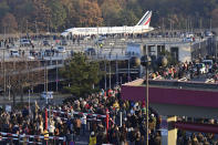 Spectators watch an Air France plane bound for Paris' Charles de Gaulle (CDG) airport driving to the runway before the last take-off from Tegel airport in Berlin, Germany, Sunday, Nov. 8, 2020. Drab and outdated but beloved for its convenience and quirky hexagonal design, Berlin's Tegel airport will finally close for good on November 8 after more than 60 years. The former West Berlin hub is being put into retirement to make way for the new Berlin Brandenburg Airport (BER), which finally opened last week after years of embarrassing delays. (John MACDOUGALL / Pool via AP)