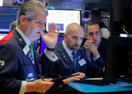 Traders work on the floor at the NYSE in New York