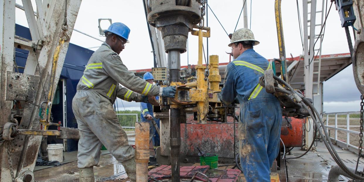 Oil workers drilling for oil on rig