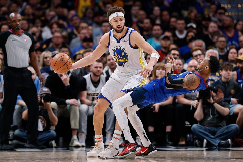 First round: Warriors guard Klay Thompson (11) tries to back down Nuggets defender Monte Morris (11) during the first half of Game 3.