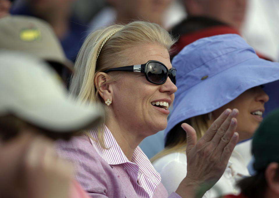 IBM CEO Virginia Rometty applauds while watching the fourth round of the Masters golf tournament from the gallery on the 18th green Sunday, April 8, 2012, in Augusta, Ga. (AP Photo/Chris O'Meara)