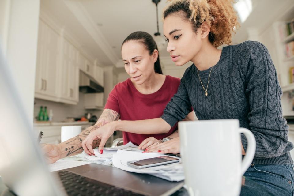 Two adults looking at paperwork. 