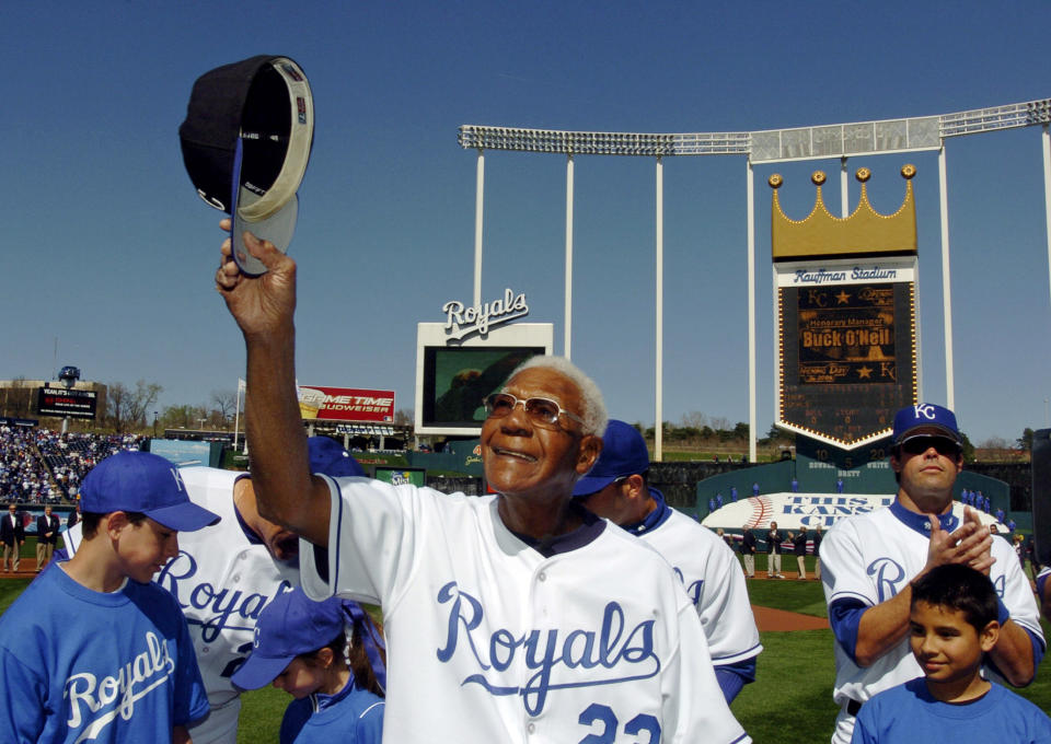 Buck O'Neil waves to fans during the Kansas City Royals home opener in this April 3, 2006 file photo. O'Neil died October 6, 2006 at age 94. He was star of the Negro Leagues, American professional baseball leagues comprising predominantly black teams starting in the early 1900's,  and was the first black major league coach.   REUTERS/Dave Kaup/Files (UNITED STATES)