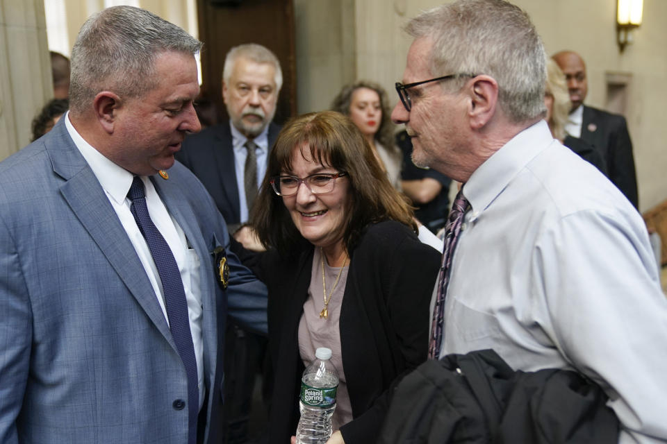 Darlene Altman, daughter of Diane Cusick, center, smiles as she leaves a courtroom in Mineola, N.Y., Monday, Dec. 5, 2022. Richard Cottingham, the serial murderer known as the "Torso Killer", admitted Monday to killing Cusick, a 23-year-old woman, outside a Long Island shopping mall in 1968 and four other women decades ago. (AP Photo/Seth Wenig)