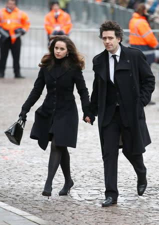 British actor Felicity Jones and film director Charlie Guard arrive at Great St Marys Church, where the funeral of theoretical physicist Prof Stephen Hawking is being held, in Cambridge, Britain, March 31, 2018. REUTERS/Henry Nicholls