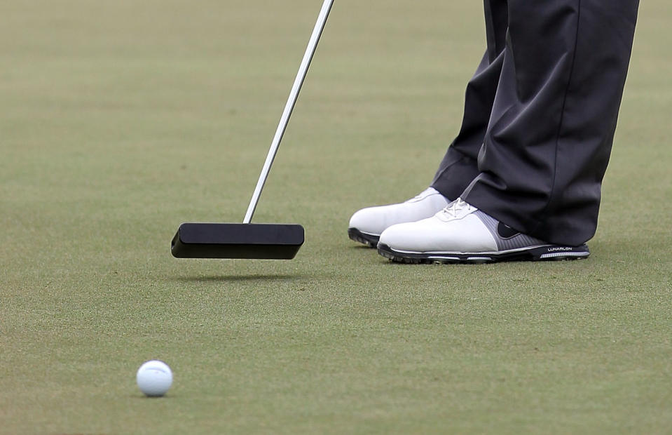 Close up of a golfer hitting a putt