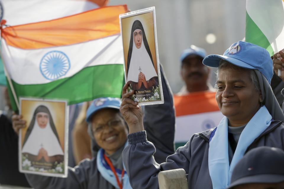 Nuns hold a picture of Maria Teresa Chiramel Mankidiyan, one of the four women to be canonized, in St. Peter's Square at the Vatican, Sunday, Oct. 13, 2019. Pope Francis canonizes Cardinal John Henry Newman, the 19th century Anglican convert who became an immensely influential thinker in both Anglican and Catholic churches, and four other women. (AP Photo/Alessandra Tarantino)