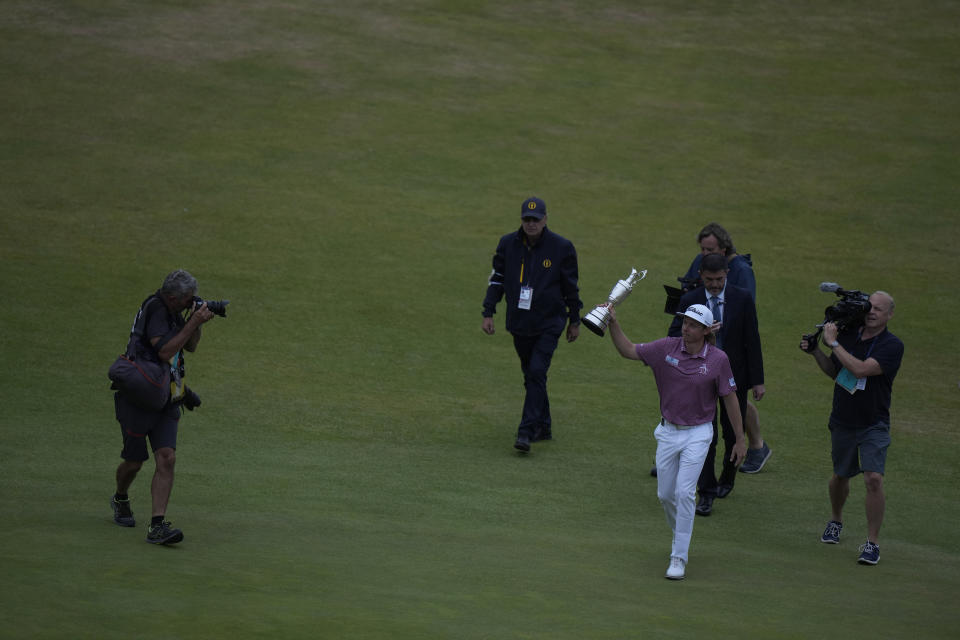 Cameron Smith, of Australia, holds the claret jug trophy after winning the British Open golf championship on the Old Course at St. Andrews, Scotland, Sunday July 17, 2022. (AP Photo/Alastair Grant)