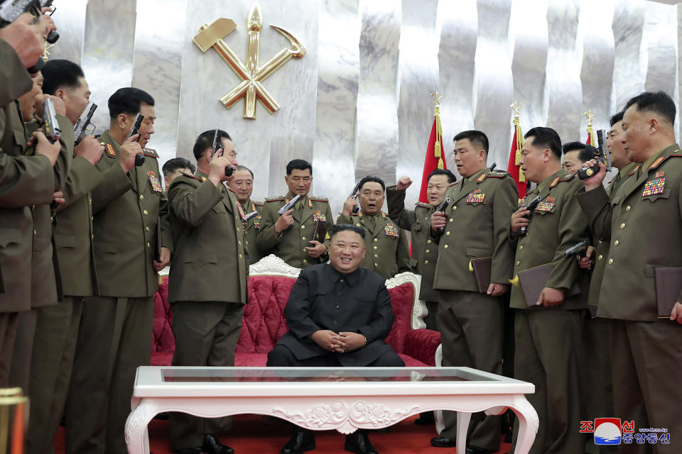 In this Sunday, July 26, 2020, photo released by the North Korean government, North Korean leader Kim Jong Un, sitting center, is surrounded by senior military officials holding “Paektusan” commemorative pistols they received from Kim during a ceremony in Pyongyang, North Korea. Independent journalists were not given access to cover the event depicted in this image distributed by the North Korean government. The content of this image is as provided and cannot be independently verified. Korean language watermark on image as provided by source reads: "KCNA" which is the abbreviation for Korean Central News Agency. (Korean Central News Agency/Korea News Service via AP)