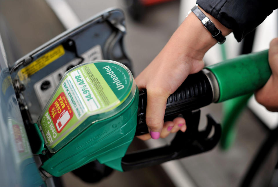 File photo dated 15/8/13 of a person using an Asda petrol pump. Nearly four out of five (78%) UK households with a vehicle have a supermarket filling station on their doorstep, a study has found.