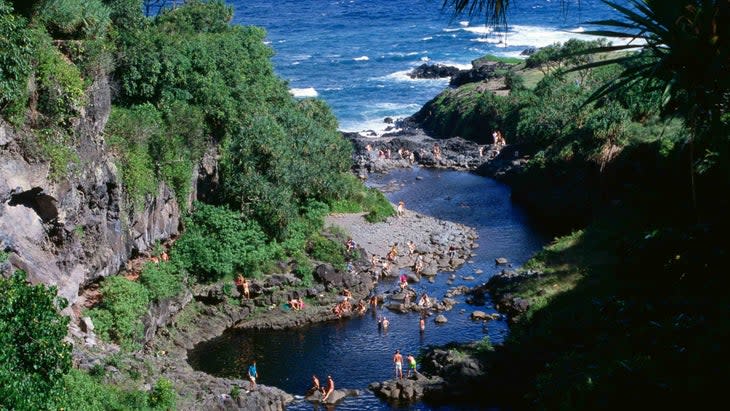 <span class="article__caption">Swimming in the Oheo Stream (Seven Pools), which flows into the Pacific </span> (Photo: John Elk/Getty)