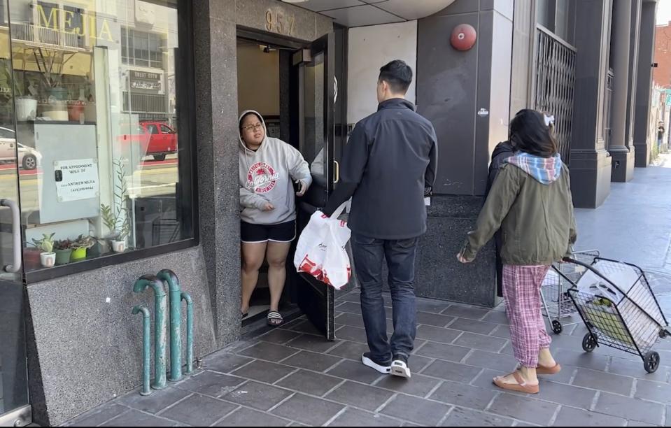 Andy Fang, DoorDash’s co-founder and chief technology officer, picks up and delivers food orders to customers in downtown San Francisco on Saturday, June 15, 2023. Fang is one of a growing number of executives who work shifts on the front lines of the companies they run. All DoorDash salaried employees are required to make deliveries or work directly with customers or merchants several times a year. (AP Photo/Terry Chea)