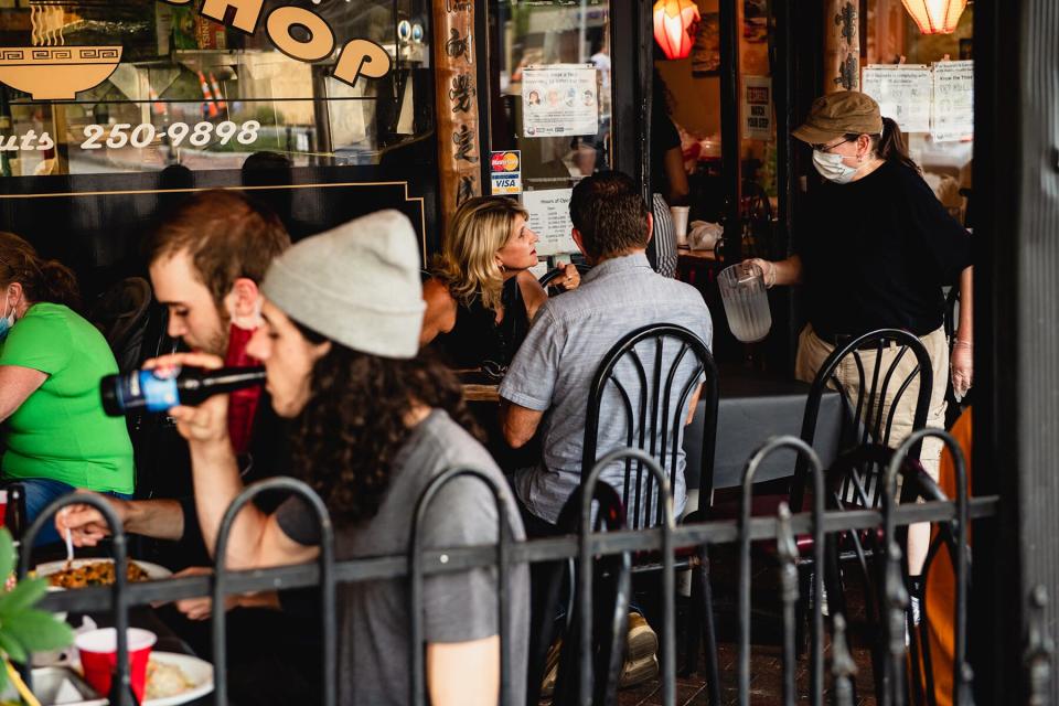 Customers at the outside seating area of a restaurant in downtown Asheville, North Carolina,
