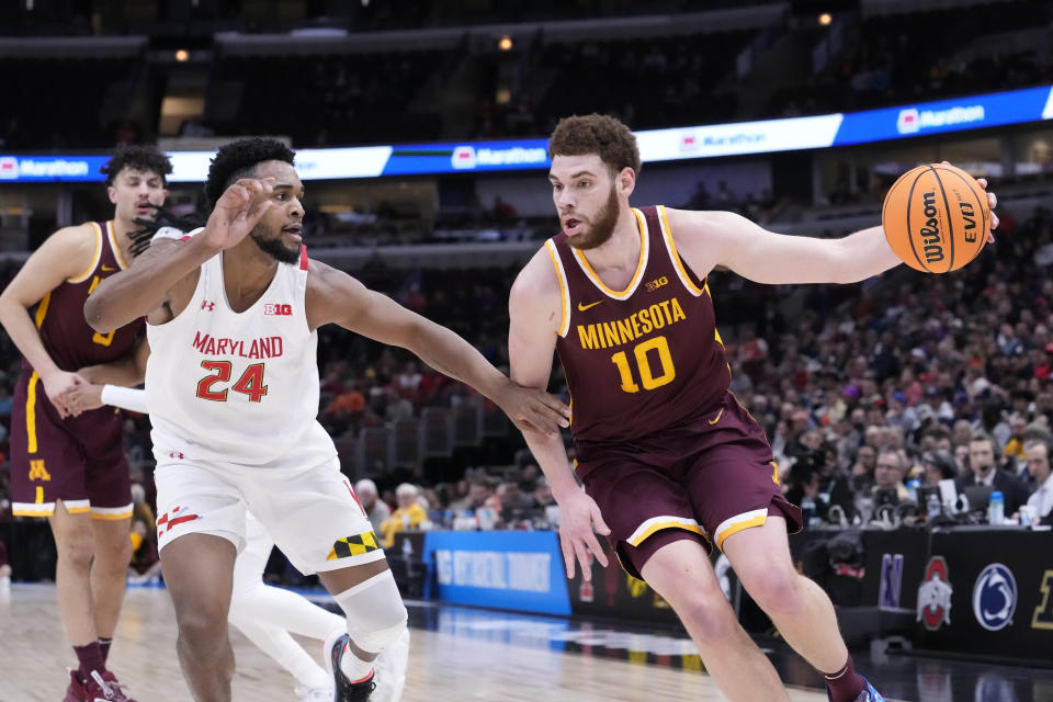 Minnesota's Jamison Battle drives to the basket as Maryland's Donta Scott defends during the first half of an NCAA college basketball game at the Big Ten men's tournament, Thursday, March 9, 2023, in Chicago. (AP Photo/Charles Rex Arbogast)
