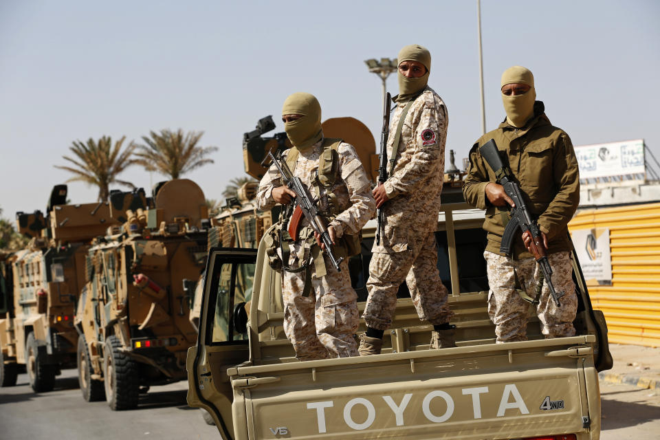 Forces loyal to Abdul Hamid Dbeibah, one of Libya’s two rival prime ministers, secure the streets of the capital, Tripoli, Tuesday May, 17, 2022. Clashes broke out in Tripoli after Dbeibah’s rival, Prime Minister Fathi Bashagha, announced his arrival in the city on Tuesday morning. But Bashagha left soon after the fighting started. (AP Photo/Yousef Murad)