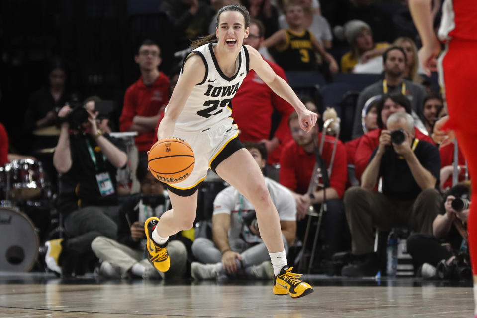 FILE - Iowa guard Caitlin Clark smiles after catching her 10th rebound to give her a triple-double against Ohio State in the second half of an NCAA college basketball championship game at the Big Ten women's tournament Sunday, March 5, 2023, in Minneapolis. Clark was honored Thursday, March 30, as The Associated Press women's college basketball Player of the Year. (AP Photo/Bruce Kluckhohn, File)