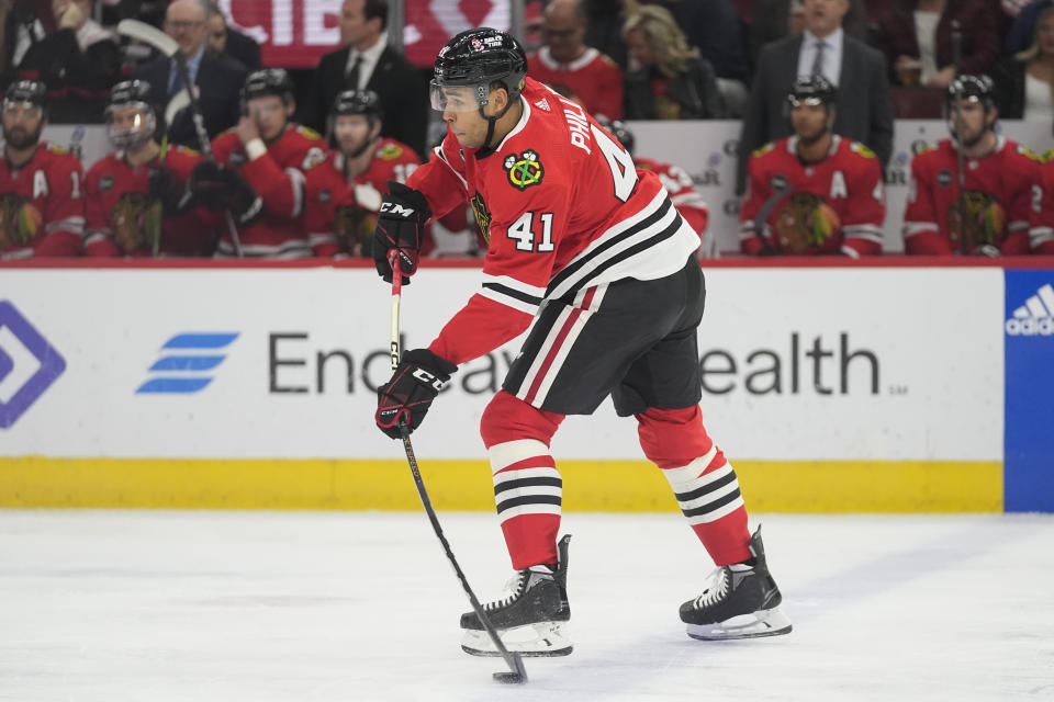Chicago Blackhawks defenseman Isaak Phillips shoots during the first period of an NHL hockey game against the Winnipeg Jets, Friday, Feb. 23, 2024, in Chicago. (AP Photo/Erin Hooley)
