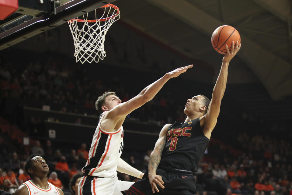 Southern California guard Kobe Johnson (0) shoots over Oregon State forward Tyler Bilodeau during the second half of an NCAA college basketball game Saturday, Dec. 30, 2023, in Corvallis, Ore. Oregon State won 86-70. (AP Photo/Amanda Loman)