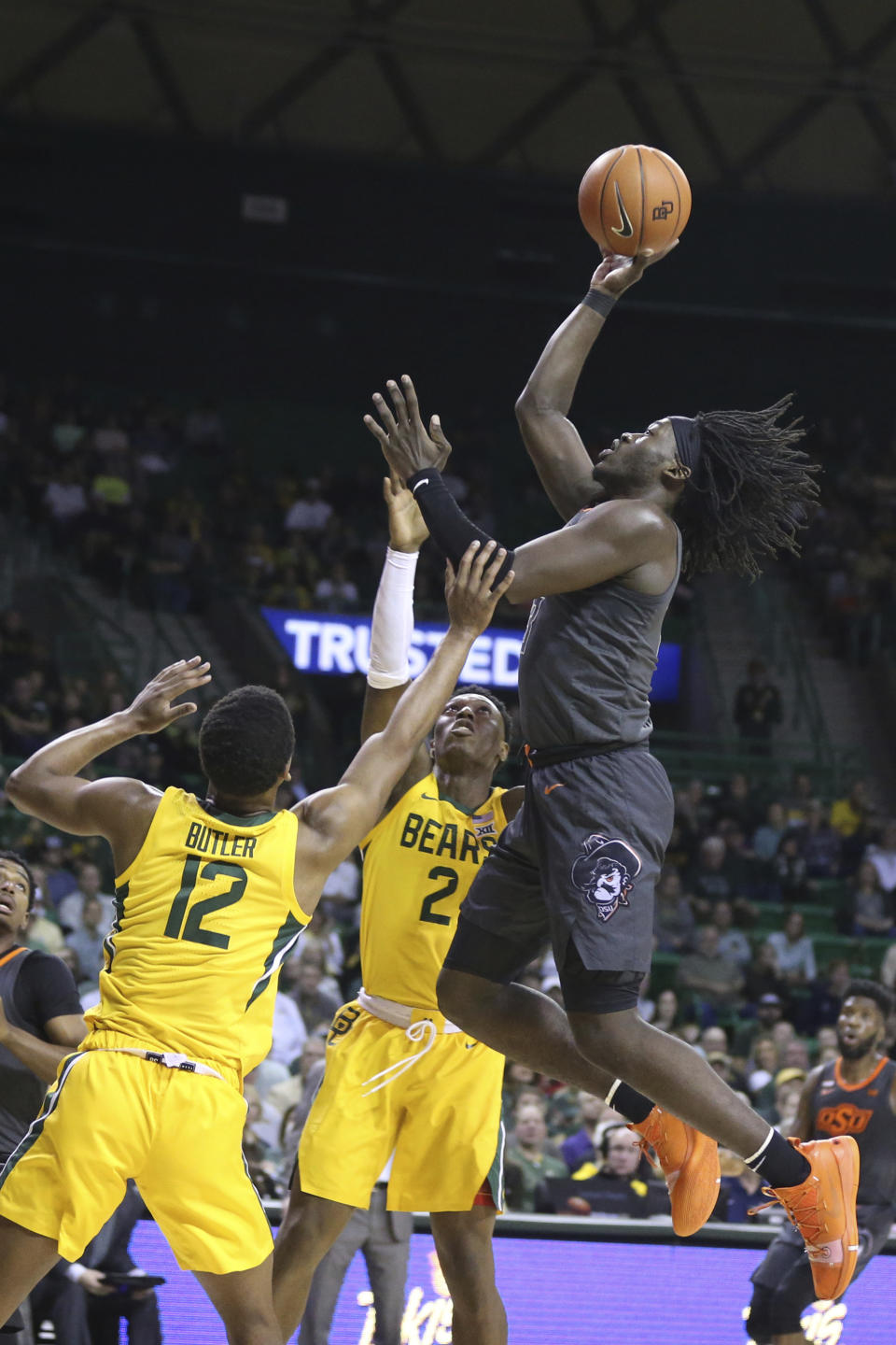 Oklahoma State guard Isaac Likekele, right, shoots over Baylor guard Jared Butler (12) during the first half of an NCAA college basketball game Saturday, Feb. 8, 2020, in Waco, Texas. (AP Photo/Rod Aydelotte)