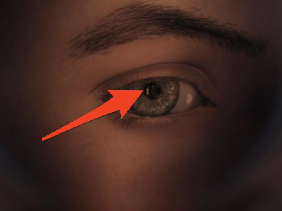 red arrow pointing to reflection in hero boys eye in polar express