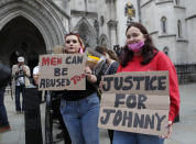 US Actor Johnny Depp supporters wait for the actor to arrive, outside the High Court in London, Tuesday, July 28, 2020. Hollywood actor Johnny Depp is suing News Group Newspapers over a story about his former wife Amber Heard, published in The Sun in 2018 which branded him a 'wife beater', a claim he denies. (AP Photo/Frank Augstein)