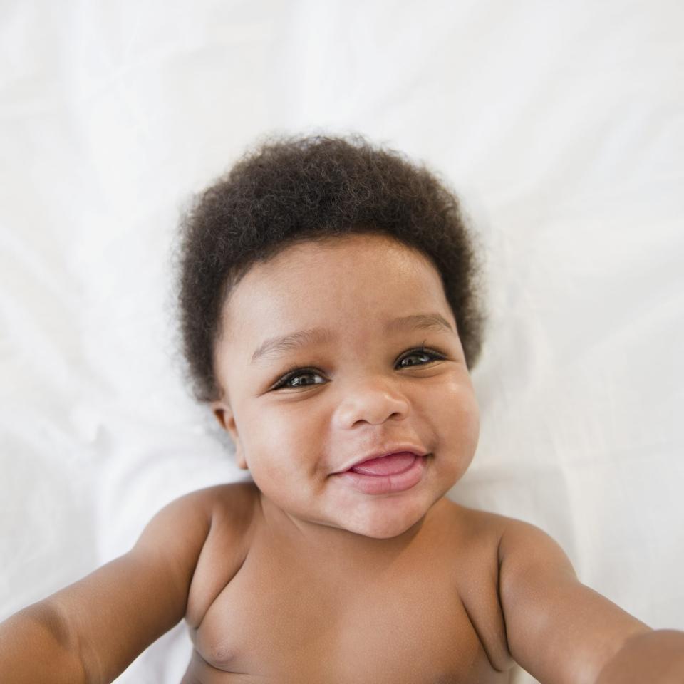 smiling baby laying on back