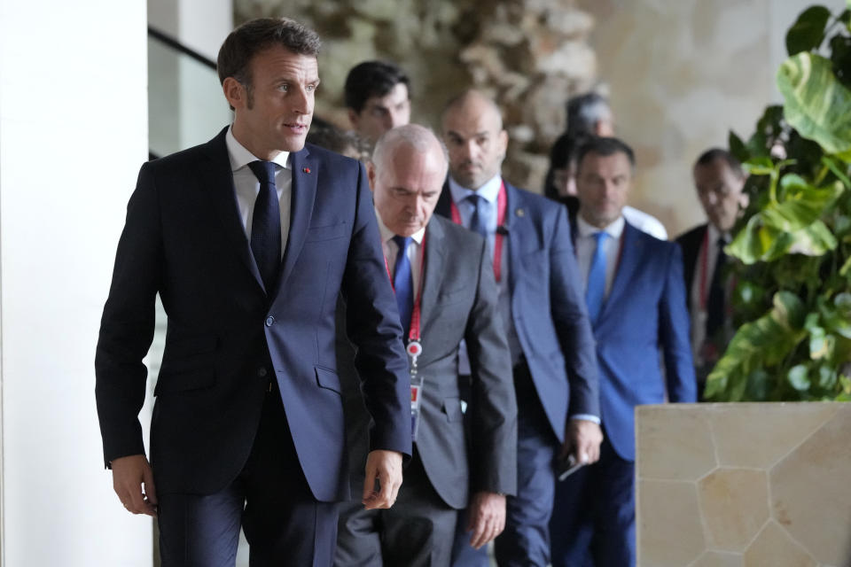 French President Emmanuel Macron, left, arrives before his meeting with Indonesia President Joko Widodo, not shown, at the G20 leaders' summit in Nusa Dua, Bali, Indonesia on Tuesday Nov. 15, 2022. (AP Photo/Achmad Ibrahim, Pool)